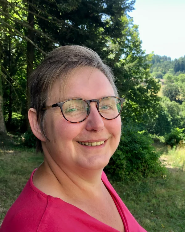 Photo of Lily Bryce in a garden.